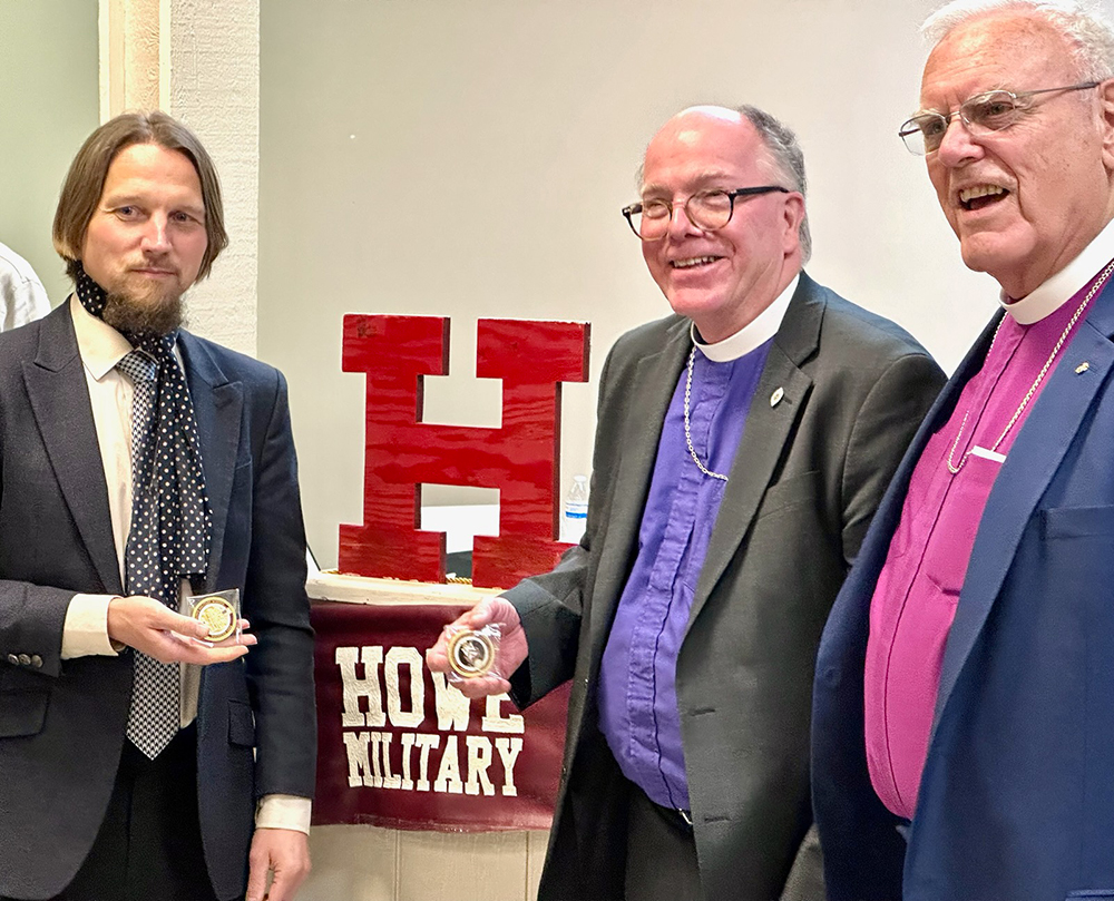 Paul Foerster holds HMSAA Challenge Coin